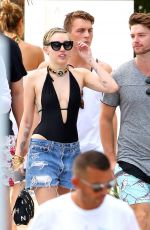 MILEY CYRUS and Patrick Schwarzenegger at a Pool in Miami