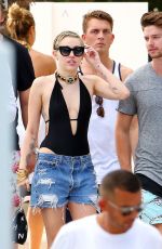 MILEY CYRUS and Patrick Schwarzenegger at a Pool in Miami