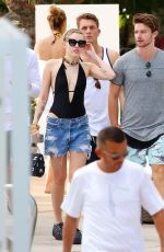 MILEY CYRUS and Patrick Schwarzenegger at a Pool in Miami