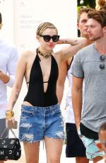 MILEY CYRUS and Patrick Schwarzenegger at a Pool in Miami