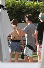 MILEY CYRUS and Patrick Schwarzenegger at a Pool in Miami
