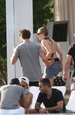 MILEY CYRUS and Patrick Schwarzenegger at a Pool in Miami