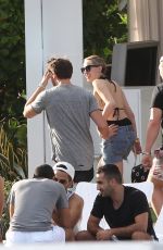 MILEY CYRUS and Patrick Schwarzenegger at a Pool in Miami