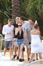 MILEY CYRUS and Patrick Schwarzenegger at a Pool in Miami