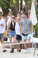 MILEY CYRUS and Patrick Schwarzenegger at a Pool in Miami