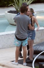 MILEY CYRUS and Patrick Schwarzenegger at a Pool in Miami