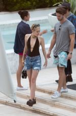 MILEY CYRUS and Patrick Schwarzenegger at a Pool in Miami