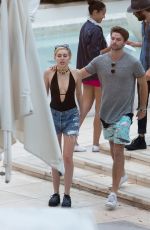 MILEY CYRUS and Patrick Schwarzenegger at a Pool in Miami