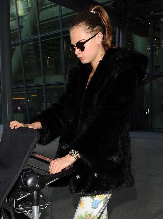 CARA DELEVINGNE at Heathrow Airport