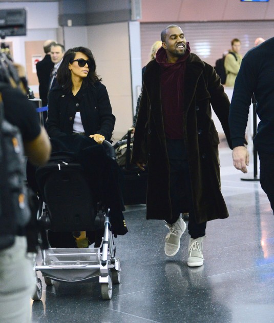 KIM KARDASHIAN and Kanye West at JFK Airport in New York KIM KARDASHIAN and Kanye West at JFK Airport