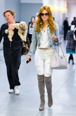 BELLA THORNE in Over-the-knee Boots at JFK Airport in New York