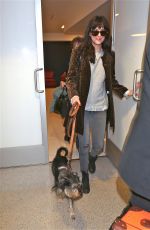 DAKOTA JOHNSON and Her Dog Arrives at Los Angeles International Airport