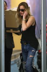 KATIE CASSIDY in Ripped Jeans at Airport in Vancouver