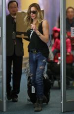 KATIE CASSIDY in Ripped Jeans at Airport in Vancouver