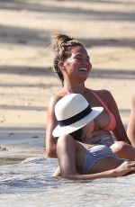 CHRISSY TEIGEN in Bikini on the Beach in The Caribbean