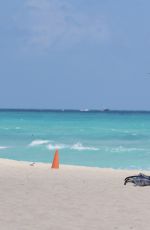 CLAUDIA ROMANI in Bikini Playing with a Dron on the Beach in Miami