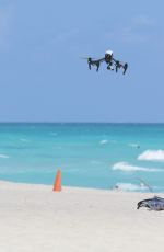 CLAUDIA ROMANI in Bikini Playing with a Dron on the Beach in Miami