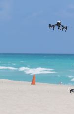 CLAUDIA ROMANI in Bikini Playing with a Dron on the Beach in Miami