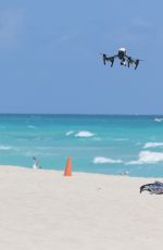 CLAUDIA ROMANI in Bikini Playing with a Dron on the Beach in Miami