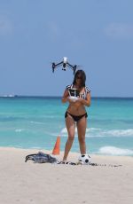 CLAUDIA ROMANI in Bikini Playing with a Dron on the Beach in Miami