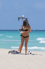 CLAUDIA ROMANI in Bikini Playing with a Dron on the Beach in Miami