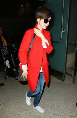 LILY COLLINS Arrives at Los Angeles International Airport