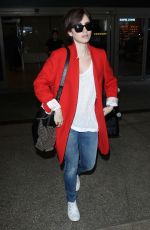 LILY COLLINS Arrives at Los Angeles International Airport