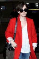 LILY COLLINS Arrives at Los Angeles International Airport