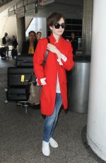 LILY COLLINS Arrives at Los Angeles International Airport