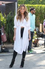 CHRISSY TEIGEN on the Set of Extra in Los Angeles