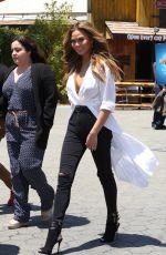 CHRISSY TEIGEN on the Set of Extra in Los Angeles