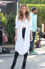CHRISSY TEIGEN on the Set of Extra in Los Angeles