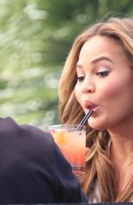 CHRISSY TEIGEN on the Set of Extra in Los Angeles