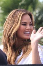 CHRISSY TEIGEN on the Set of Extra in Los Angeles