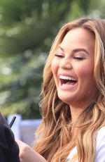 CHRISSY TEIGEN on the Set of Extra in Los Angeles