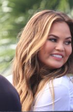 CHRISSY TEIGEN on the Set of Extra in Los Angeles