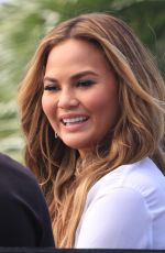 CHRISSY TEIGEN on the Set of Extra in Los Angeles