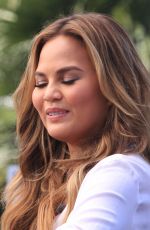 CHRISSY TEIGEN on the Set of Extra in Los Angeles