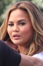 CHRISSY TEIGEN on the Set of Extra in Los Angeles