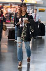 RIHANNA in Ripped Jeans at JFK Airport 04/30/2015
