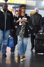 RIHANNA in Ripped Jeans at JFK Airport 04/30/2015