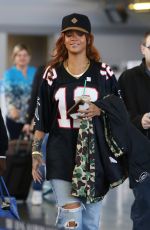 RIHANNA in Ripped Jeans at JFK Airport 04/30/2015