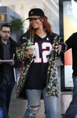 RIHANNA in Ripped Jeans at JFK Airport 04/30/2015