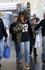 RIHANNA in Ripped Jeans at JFK Airport 04/30/2015