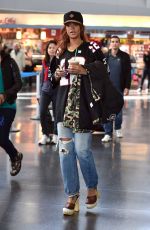 RIHANNA in Ripped Jeans at JFK Airport 04/30/2015