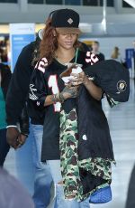RIHANNA in Ripped Jeans at JFK Airport 04/30/2015