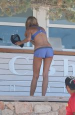 KIMBERLEY GARNER in Shorts and Tank Top Working on the Beach in Ibiza