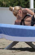 MICHELLE HUNZIKER in Bikini on Vocation at a Beach in Italy 06/16/2015