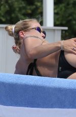 MICHELLE HUNZIKER in Bikini on Vocation at a Beach in Italy 06/16/2015