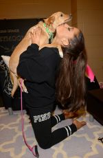ARIANA GRANDE Plays with Dogs in New York